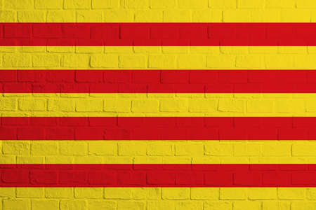 Flag of Catalonia. Brick wall texture of the flag of Catalonia.の写真素材