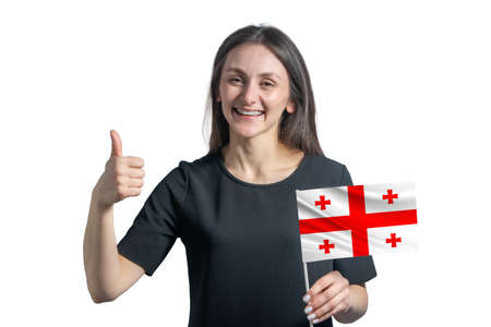 Happy young white woman holding flag of Georgia and shows the class by hand isolated on a white background.の写真素材