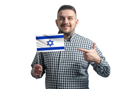 White guy holding a flag of Israel and points the finger of the other hand at the flag isolated on a white background.の写真素材