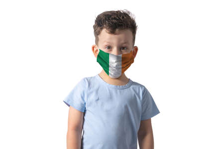 Respirator with flag of Ireland White boy puts on medical face mask isolated on white background.の写真素材
