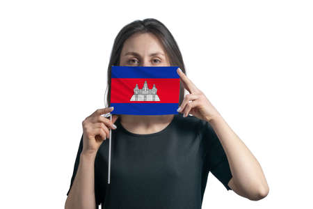 Happy young white woman holding flag Cambodia flag and covers her face with it isolated on a white background.の写真素材
