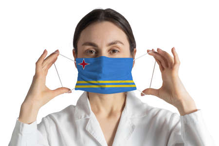 Respirator with flag of Aruba Doctor puts on medical face mask isolated on white background.の写真素材