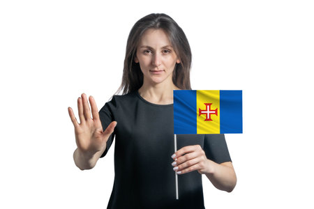 Happy young white woman holding flag of Madeira and with a serious face shows a hand stop sign isolated on a white background.の写真素材