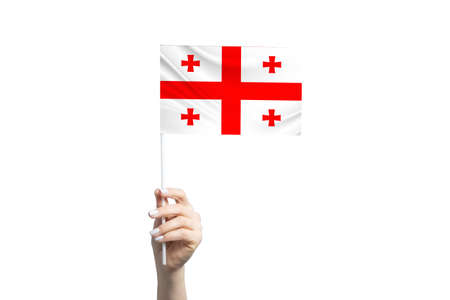 Beautiful female hand holding Georgia flag, isolated on white background.の写真素材