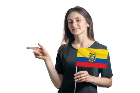 Happy young white woman holding flag Ecuador and points to the left isolated on a white background.の写真素材