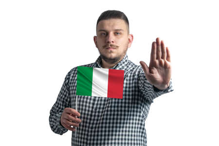 White guy holding a flag of Italy and with a serious face shows a hand stop sign isolated on a white background.の写真素材