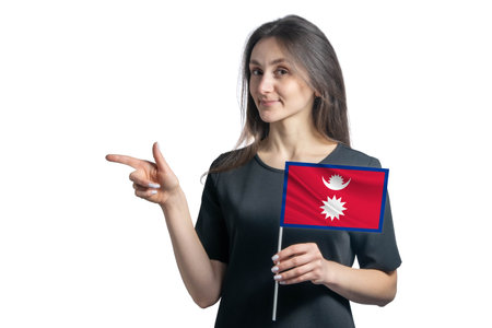 Happy young white woman holding flag Nepal and points to the left isolated on a white backgroundの写真素材