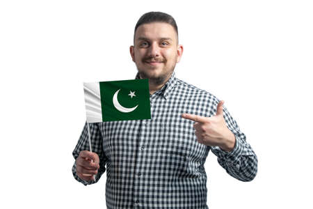 White guy holding a flag of Pakistan and points the finger of the other hand at the flag isolated on a white backgroundの写真素材