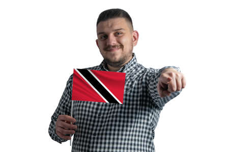 White guy holding a flag of Trinidad and Tobago and points forward in front of him isolated on a white background.の写真素材