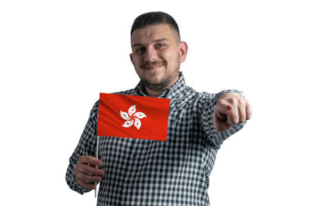 White guy holding a flag of Hong Kong and points forward in front of him isolated on a white background.の写真素材