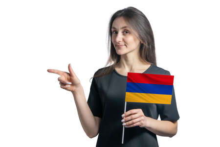 Happy young white woman holding flag Armenia and points to the left isolated on a white background.の写真素材