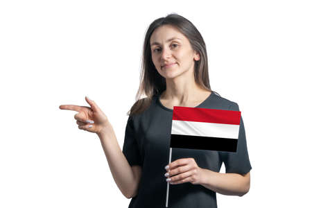 Happy young white woman holding flag Yemen and points to the left isolated on a white background.の写真素材
