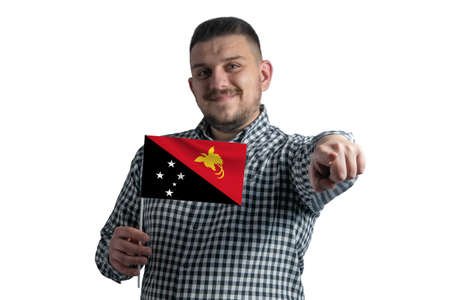White guy holding a flag of Papua New Guinea and points forward in front of him isolated on a white background.の写真素材