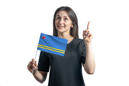 Happy young white woman holding flag of Aruba and points thumbs up isolated on a white background.の写真素材
