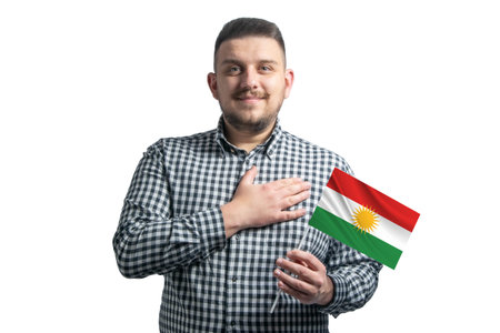 White guy holding a flag of Kurdistan and holds his hand on his heart isolated on a white background With love to Kurdistan.の写真素材