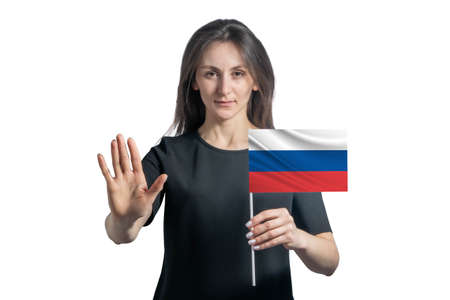 Happy young white woman holding flag of Russia and with a serious face shows a hand stop sign isolated on a white background.の写真素材