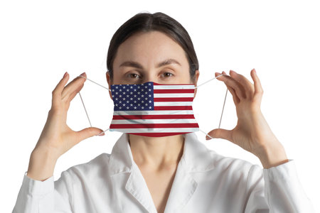 Respirator with flag of United States Doctor puts on medical face mask isolated on white background.の写真素材