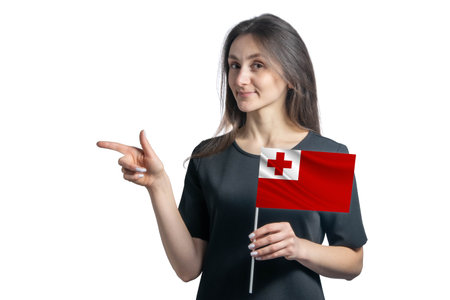 Happy young white woman holding flag Tonga and points to the left isolated on a white background.の写真素材