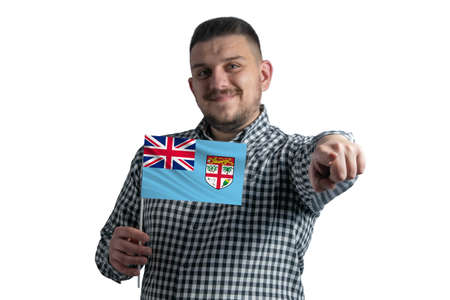 White guy holding a flag of Fiji and points forward in front of him isolated on a white background.の写真素材