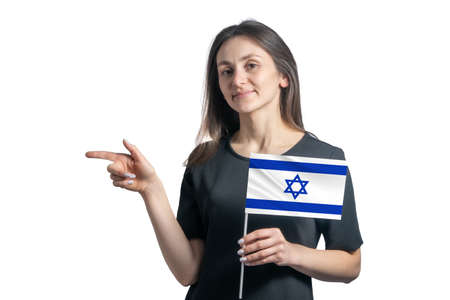 Happy young white woman holding flag Israel and points to the left isolated on a white background.の写真素材