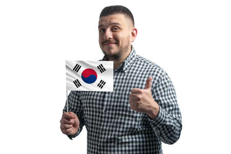 White guy holding a flag of South Korea and shows the class by hand isolated on a white background. Like for South Korea.の写真素材