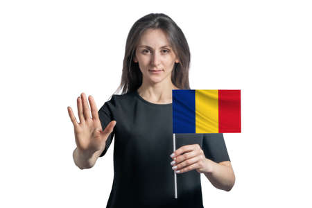 Happy young white woman holding flag of Romania and with a serious face shows a hand stop sign isolated on a white background.の写真素材