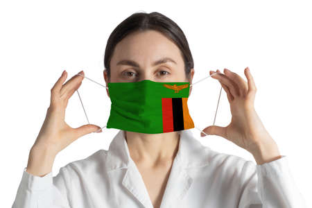 Respirator with flag of Zambia Doctor puts on medical face mask isolated on white background.の写真素材