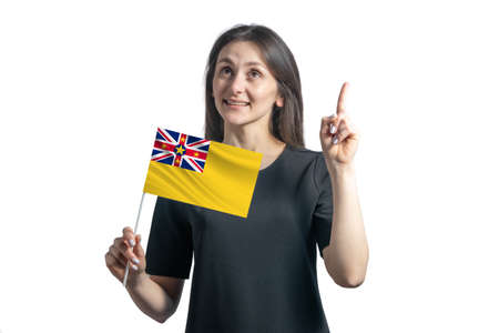 Happy young white woman holding flag of Niue and points thumbs up isolated on a white background.の写真素材