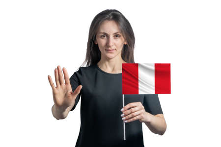 Happy young white woman holding flag of Peru and with a serious face shows a hand stop sign isolated on a white background.の写真素材