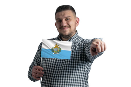 White guy holding a flag of San Marino and points forward in front of him isolated on a white background.の写真素材