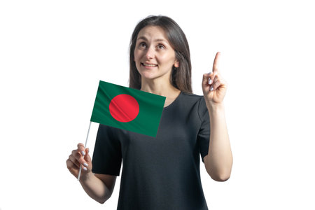 Happy young white woman holding flag of Bangladesh and points thumbs up isolated on a white background.の写真素材