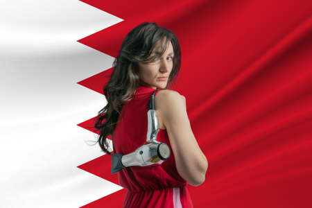Beauty industry in Bahrain. Happy female hairdresser holding hairdryer against Bahrain flag backgroundの写真素材