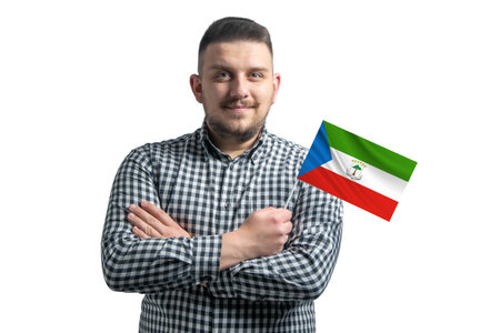 White guy holding a flag of Equatorial Guinea smiling confident with crossed arms isolated on a white background.の写真素材