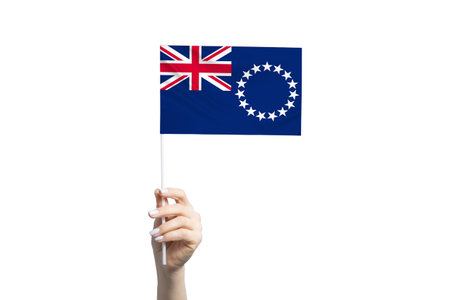 Beautiful female hand holding Cook Islands flag, isolated on white background.の写真素材