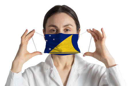 Respirator with flag of Tokelau Doctor puts on medical face mask isolated on white background.の写真素材