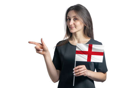Happy young white woman holding flag England and points to the left isolated on a white background.の写真素材