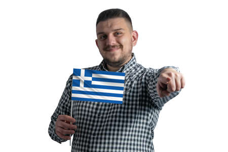 White guy holding a flag of Greece and points forward in front of him isolated on a white background.の写真素材