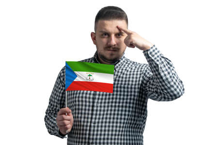 White guy holding a flag of Equatorial Guinea and a finger touches the temple on the head isolated on a white background.の写真素材