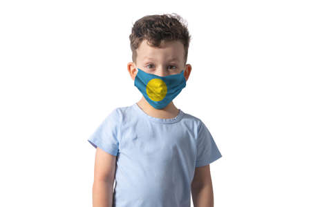 Respirator with flag of Palau. White boy puts on medical face mask isolated on white background.の写真素材