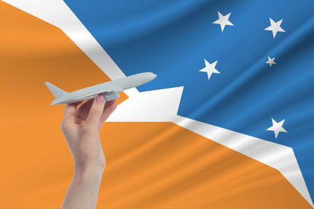 Airplane in hand with national flag of Argentine Antarctica. Travel to Argentine Antarcticaの写真素材