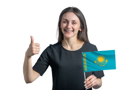 Happy young white woman holding flag of Kazakhstan and shows the class by hand isolated on a white background.の写真素材