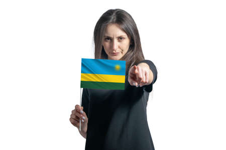 Happy young white woman holding flag of Rwanda and points forward in front of him isolated on a white background.の写真素材