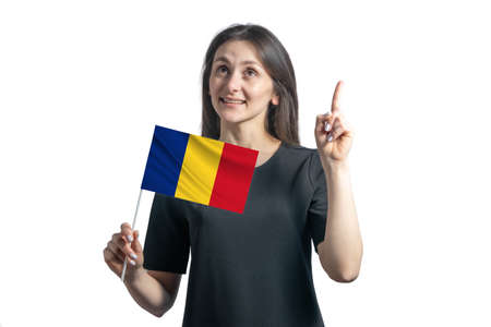 Happy young white woman holding flag of Romania and points thumbs up isolated on a white background.の写真素材