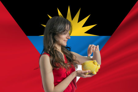 Economy in Antigua and Barbuda. Accumulating and saving money in Antigua and Barbuda. Woman putting money coin in piggy bank for saving money and plan finance.の写真素材