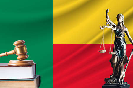 Law and justice in Benin. Statue of themis and the gavel of the judge against the background of the flag of Benin. Law and justice concept.の写真素材