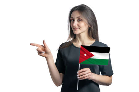 Happy young white woman holding flag Jordan and points to the left isolated on a white background.の写真素材