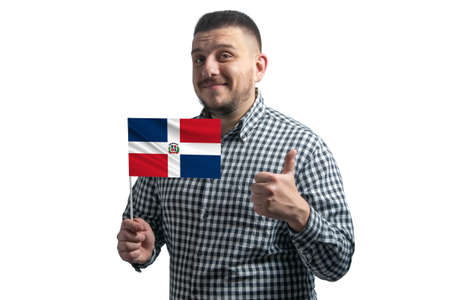 White guy holding a flag of Dominican Republic and shows the class by hand isolated on a white background. Like for Dominican Republic.の写真素材