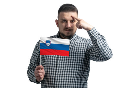 White guy holding a flag of Slovenia and a finger touches the temple on the head isolated on a white background.の写真素材
