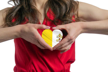 Love Vatican. The woman holds a heart in the form of the flag of Vatican on her chest. Concept of patriotism.の写真素材