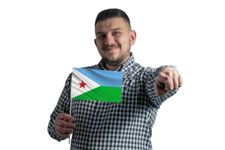 White guy holding a flag of Djibouti and points forward in front of him isolated on a white background.の写真素材